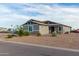 Gray house exterior with landscaping and a gravel driveway at 10447 W Appaloosa Trl, Casa Grande, AZ 85194