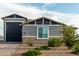 Gray house exterior with a brick accent and landscaping at 10447 W Appaloosa Trl, Casa Grande, AZ 85194