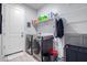 Laundry room with washer, dryer, and storage shelves at 10447 W Appaloosa Trl, Casa Grande, AZ 85194