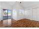 Bedroom with sliding door to patio and wood floors at 10836 N 29Th Ave, Phoenix, AZ 85029