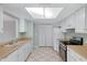 Galley kitchen with white cabinets and wood countertops at 10836 N 29Th Ave, Phoenix, AZ 85029