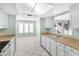 View of kitchen with a breakfast nook and white cabinets at 10836 N 29Th Ave, Phoenix, AZ 85029