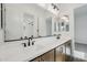 Elegant bathroom featuring dual sinks, modern fixtures, and a well-lit mirror at 11441 E Utah Ave, Mesa, AZ 85212