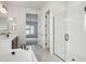 Luxurious bathroom featuring a soaking tub, double vanity, and glass enclosed shower with a view to a carpeted room at 11441 E Utah Ave, Mesa, AZ 85212