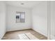 Sunny bedroom featuring wood-look tile flooring, and large window at 11441 E Utah Ave, Mesa, AZ 85212