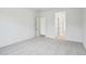 A clean and spacious bedroom with plush carpeting and an open doorway leading to other areas of the house at 11441 E Utah Ave, Mesa, AZ 85212
