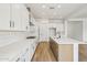 Bright kitchen features white cabinets, stainless steel appliances, and a large center island with breakfast bar at 11441 E Utah Ave, Mesa, AZ 85212