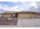 Single-story house with a two-car garage and landscaped front yard at 11461 E Natal Ave, Mesa, AZ 85209