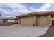 Two-car garage with an attached carport and a flag at 11461 E Natal Ave, Mesa, AZ 85209