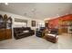 Spacious living room with leather furniture and a view into the kitchen at 11461 E Natal Ave, Mesa, AZ 85209