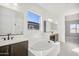 Elegant bathroom featuring a freestanding bathtub and double sinks at 11464 E Utah Ave, Mesa, AZ 85212