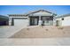 Gray house with a two-car garage and front landscaping at 11464 E Utah Ave, Mesa, AZ 85212