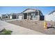 New construction home with gray siding and a two-car garage.Landscaped yard at 11464 E Utah Ave, Mesa, AZ 85212