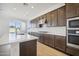 Dark wood cabinets, white quartz countertops, and stainless steel appliances in this kitchen at 11464 E Utah Ave, Mesa, AZ 85212