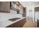 Modern kitchen with stainless steel range hood and white subway tile backsplash at 11464 E Utah Ave, Mesa, AZ 85212