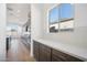 Kitchen with white subway tile backsplash, quartz countertops, and dark cabinets at 11464 E Utah Ave, Mesa, AZ 85212