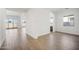 Bright living room with wood-look tile flooring and sliding glass door access to backyard at 11464 E Utah Ave, Mesa, AZ 85212