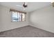 Well-lit bedroom with ceiling fan and window at 12611 W Gable Hill Dr, Sun City West, AZ 85375