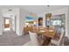 Dining room with a wood table, chandelier, and access to a patio at 12611 W Gable Hill Dr, Sun City West, AZ 85375