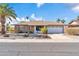 Single-story home with a two-car garage and desert landscaping at 12611 W Gable Hill Dr, Sun City West, AZ 85375