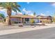 Front view of a ranch style house with a large palm tree at 12611 W Gable Hill Dr, Sun City West, AZ 85375