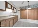 Bright kitchen features wood cabinets, tiled floors and a modern faucet at 12611 W Gable Hill Dr, Sun City West, AZ 85375