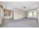 Living room features a ceiling fan, window and built-in shelving at 12611 W Gable Hill Dr, Sun City West, AZ 85375