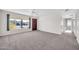 Living room with a view of the front yard and a hallway to other rooms at 12611 W Gable Hill Dr, Sun City West, AZ 85375