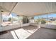 Screened patio with flagstone floor and backyard view at 12611 W Gable Hill Dr, Sun City West, AZ 85375