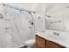 Clean bathroom with marble shower and wood vanity at 13407 N Primrose St, El Mirage, AZ 85335