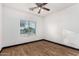 Well-lit bedroom featuring wood-look floors and a window with blinds at 13407 N Primrose St, El Mirage, AZ 85335