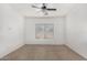 Well-lit bedroom with ceiling fan and window coverings at 13407 N Primrose St, El Mirage, AZ 85335