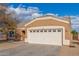 House exterior with a two-car garage and desert landscaping at 13407 N Primrose St, El Mirage, AZ 85335