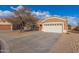 House exterior with a two-car garage and landscaped yard at 13407 N Primrose St, El Mirage, AZ 85335