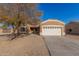 Tan house with a two-car garage, tree, and driveway at 13407 N Primrose St, El Mirage, AZ 85335