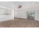 Living room with tile floors, sliding door, and kitchen view at 13407 N Primrose St, El Mirage, AZ 85335