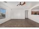 Living room with tile floors, window, and ceiling fan at 13407 N Primrose St, El Mirage, AZ 85335