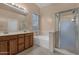 Bathroom with double sinks, soaking tub, and shower at 14248 W Edgemont Ave, Goodyear, AZ 85395