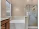 Bathroom featuring a large soaking tub and shower at 14248 W Edgemont Ave, Goodyear, AZ 85395