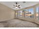 Spacious bedroom with ceiling fan and large windows at 14248 W Edgemont Ave, Goodyear, AZ 85395