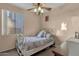 Bedroom with a full-size bed and ceiling fan at 14248 W Edgemont Ave, Goodyear, AZ 85395