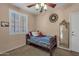 Cozy bedroom with a twin bed and window shutters at 14248 W Edgemont Ave, Goodyear, AZ 85395