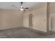 Bright bedroom with ceiling fan and ensuite bathroom access at 14248 W Edgemont Ave, Goodyear, AZ 85395