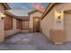 Well-lit house exterior at dusk with a covered entryway and decorative door at 14248 W Edgemont Ave, Goodyear, AZ 85395