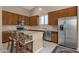 Modern kitchen with stainless steel appliances and wood cabinets at 14248 W Edgemont Ave, Goodyear, AZ 85395