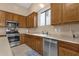 Kitchen with wood cabinets, stainless steel appliances, and tile floor at 14248 W Edgemont Ave, Goodyear, AZ 85395