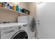 Laundry room with washer, dryer, and shelving at 14248 W Edgemont Ave, Goodyear, AZ 85395