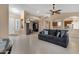 Living room with gray couch and views into other rooms at 14248 W Edgemont Ave, Goodyear, AZ 85395