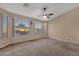 Spacious main bedroom with large windows and carpet flooring at 14248 W Edgemont Ave, Goodyear, AZ 85395