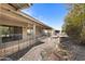 Back exterior of house showing patio, fire pit, and rock landscaping at 1505 Leisure World --, Mesa, AZ 85206